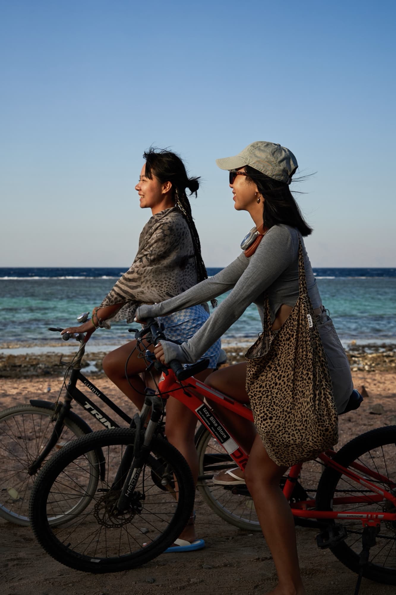Girl riding a bike by the sea